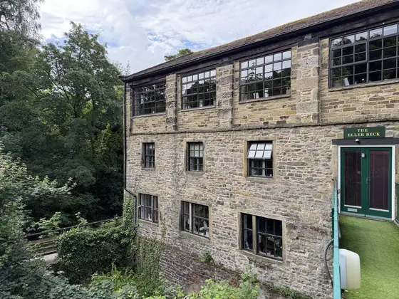 The holiday let entrance in the mill building, painted green