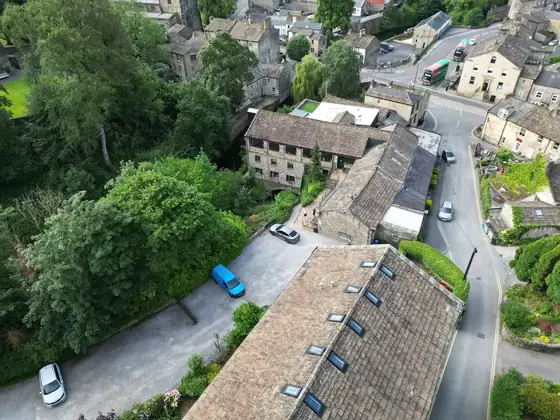 The mill roofs and the lane below seen from the air