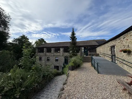 The gravel yard behind the mill under a wide sky