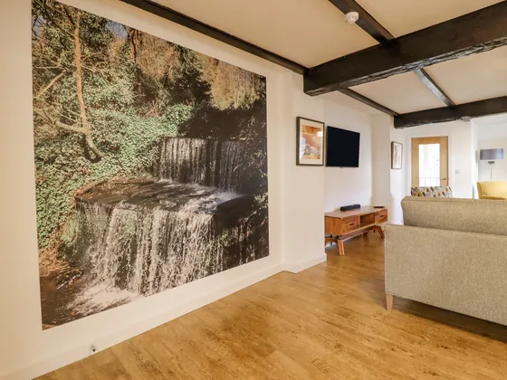 A printed waterfall covering the end wall of the living space