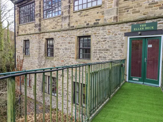 The terrace outside the apartment, with a green railing above the beck