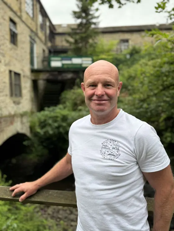 A High Corn Mill tour guide beside the Eller Beck